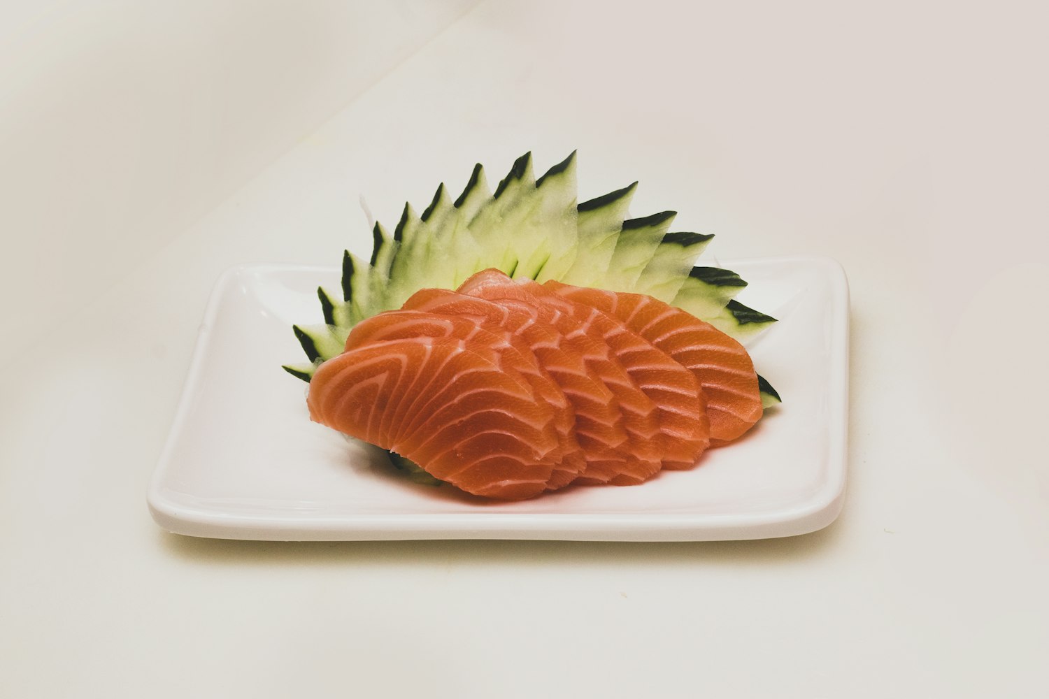 A clean block of cured salmon on a pale plate