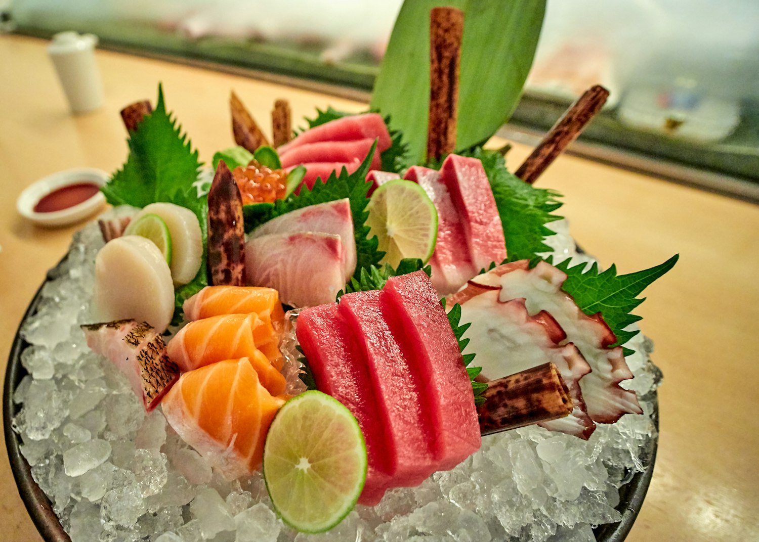 A seasonal sashimi course plated on stone at the HINATA counter